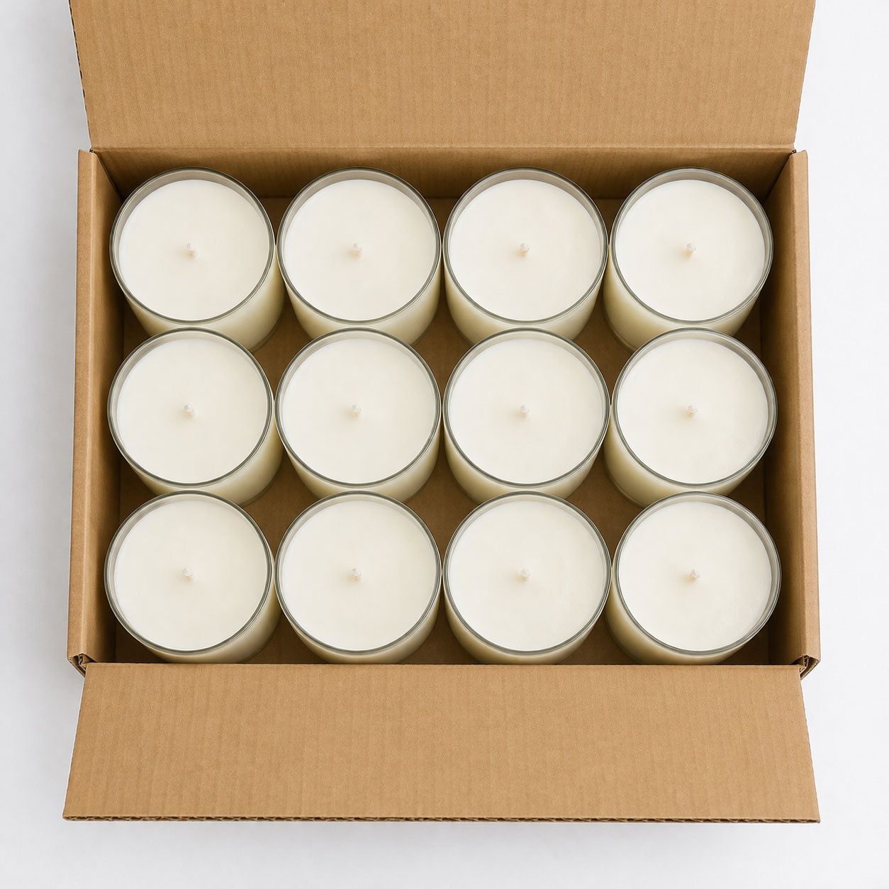 Box showing all 12 of the 11oz tumbler candles in a packaging box. This is an overhead shot with the box open.
