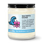 Candle with a label describing the scent 'Sea Salt & Orchid' on a white background