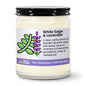 White Sage & Lavender candle in a glass jar with a black lid on a white background
